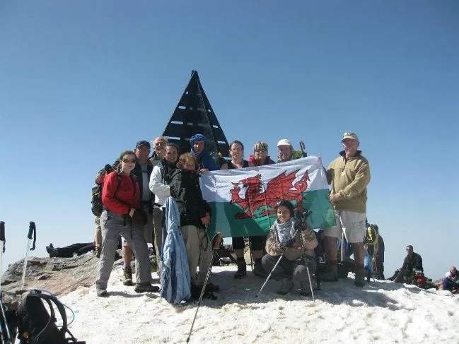 Group of Tourists are in the Peak of Toubkal Mountain Embracing the Challenge Preparing for Your Atlas Mountain Trek 